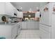 Well-lit kitchen with stainless steel appliances, white cabinets, and plenty of counter space at 3056 Saint Thomas Ln, The Villages, FL 32162