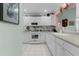 Functional kitchen featuring white cabinetry, modern appliances, and a tiled backsplash at 3056 Saint Thomas Ln, The Villages, FL 32162