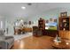 Bright living room boasts wood laminate flooring and a dining area with natural light at 3056 Saint Thomas Ln, The Villages, FL 32162