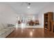 Open living room with tile and wood flooring, with a view of the front entrance and an adjacent dining area at 3056 Saint Thomas Ln, The Villages, FL 32162