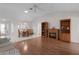 Inviting living room featuring wood floors, a fireplace, and an adjacent dining area with tiled floor at 3056 Saint Thomas Ln, The Villages, FL 32162