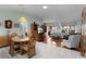 Open-concept living room with wood and tile flooring, seamlessly connecting living and dining spaces at 3056 Saint Thomas Ln, The Villages, FL 32162