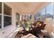 Cozy sunroom with wicker furniture, ceiling fan, and lots of natural light at 3056 Saint Thomas Ln, The Villages, FL 32162