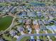 Aerial view of a cozy one-story home near a picturesque lake and an expansive golf course at 3142 Islawild Way, The Villages, FL 32163