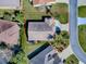 A bird's eye view of a single story residence with mature landscaping and a long driveway at 3142 Islawild Way, The Villages, FL 32163