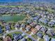 An aerial shot showcasing a one-story home near scenic lakes and a well-manicured golf course at 3142 Islawild Way, The Villages, FL 32163