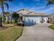 Charming single-story home featuring a well-manicured lawn and three-car garage at 3142 Islawild Way, The Villages, FL 32163