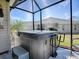 Hot tub on screened in lanai with view of backyard at 3142 Islawild Way, The Villages, FL 32163