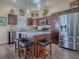 Modern kitchen featuring stainless steel appliances, an island with barstool seating, and pendant lighting at 3142 Islawild Way, The Villages, FL 32163