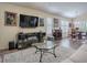 Spacious living room with hardwood floors, neutral colors, and an open layout leading to the dining area at 3142 Islawild Way, The Villages, FL 32163