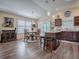 Open floorplan featuring the kitchen island, dining area and a built in china hutch with hardwood floors at 3142 Islawild Way, The Villages, FL 32163