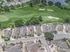 Aerial view of home in golf community featuring mature trees and landscaping at 3285 Archer Ave, The Villages, FL 32162