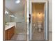 Bathroom featuring a stand-up shower, dual sinks, and a separate toilet at 3285 Archer Ave, The Villages, FL 32162