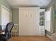 This bedroom features a murphy bed for flexible living, offering an open and inviting space with ample storage at 3285 Archer Ave, The Villages, FL 32162