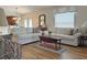 Comfortable living room with two sofas, a wooden coffee table, and lots of natural light at 3285 Archer Ave, The Villages, FL 32162