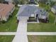 An aerial view showcases a single-Gathering home with a new roof, lush lawn and manicured landscaping at 3435 Tumbling River Dr, Clermont, FL 34711