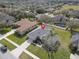 Aerial view of a well-maintained home featuring a spacious lot with mature trees and landscaping at 3435 Tumbling River Dr, Clermont, FL 34711