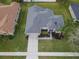 An aerial view showcases a single-Gathering home with a new roof, lush lawn and manicured landscaping at 3435 Tumbling River Dr, Clermont, FL 34711