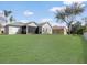 Spacious backyard with a well-maintained lawn, offering ample space for recreation and outdoor enjoyment at 3435 Tumbling River Dr, Clermont, FL 34711