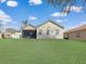 Expansive backyard featuring a screened lanai and lush green lawn, perfect for outdoor activities and relaxation at 3435 Tumbling River Dr, Clermont, FL 34711