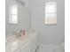 Bathroom featuring a marble countertop, large mirror, and natural light from the window at 3435 Tumbling River Dr, Clermont, FL 34711