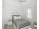 Bedroom featuring a plush bed with silver accents, a ceiling fan, and natural light at 3435 Tumbling River Dr, Clermont, FL 34711