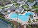 Aerial view of community clubhouse and pool with ample seating, perfect for relaxation and socializing at 3435 Tumbling River Dr, Clermont, FL 34711