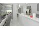 Kitchen area with stainless steel appliances and quartz countertops with gray cabinets in an open space at 3435 Tumbling River Dr, Clermont, FL 34711