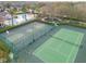 Aerial view of a tennis and basketball courts with community pool and playground in the background at 3435 Tumbling River Dr, Clermont, FL 34711