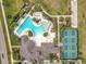 Aerial view of the community pool, clubhouse, tennis courts, and well-manicured landscaping at 3449 Meadow Beauty Way, Clermont, FL 34714