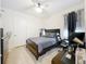 Bedroom featuring a desk, and a dark wood bed frame, illuminated by a modern ceiling fan at 3449 Meadow Beauty Way, Clermont, FL 34714