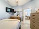 Cozy bedroom featuring a TV, dresser, and light blue walls that create a serene and calming atmosphere at 3449 Meadow Beauty Way, Clermont, FL 34714