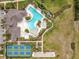 Overhead view of the community pool, hot tub, tennis court and clubhouse with ample parking at 3449 Meadow Beauty Way, Clermont, FL 34714