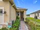 Charming front entrance with a brick walkway, a beautiful yard, and a lake view at 3449 Meadow Beauty Way, Clermont, FL 34714