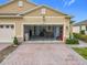 Spacious two-car garage with ample storage space and a well-maintained brick driveway at 3449 Meadow Beauty Way, Clermont, FL 34714