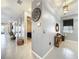 Spacious hallway with elegant mirrors, decorative baskets, and neutral gray tones, leading to various rooms at 3449 Meadow Beauty Way, Clermont, FL 34714