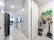 Laundry room with shelving and washer and dryer, adjacent to the kitchen at 3449 Meadow Beauty Way, Clermont, FL 34714