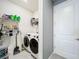 Neat laundry area with shelving, washer, dryer, and white door at 3449 Meadow Beauty Way, Clermont, FL 34714