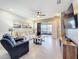 Relaxing living room with neutral colors, ceiling fan, sliding doors to the patio, and comfortable seating at 3449 Meadow Beauty Way, Clermont, FL 34714