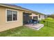 This patio provides a relaxed setting complete with outdoor chairs, an umbrella, and a BBQ grill at 3449 Meadow Beauty Way, Clermont, FL 34714