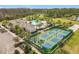 Aerial view of the community clubhouse, swimming pool, and fenced-in tennis and pickleball courts at 3449 Meadow Beauty Way, Clermont, FL 34714