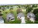 Aerial view of homes near a pond and golf course, showcasing the neighborhood's recreational amenities at 3720 Eversholt St, Clermont, FL 34711