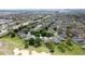 An aerial view of a residential area with houses surrounding golf course and greenery at 3720 Eversholt St, Clermont, FL 34711