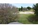 Backyard landscape featuring mature trees and views of a golf course at 3720 Eversholt St, Clermont, FL 34711