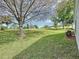 Expansive backyard view featuring lush green grass and mature trees creating a serene outdoor space at 3720 Eversholt St, Clermont, FL 34711