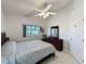 This is the bedroom featuring a bed, dresser, a view through a window, and a door at 3720 Eversholt St, Clermont, FL 34711