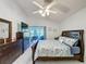 Spacious bedroom featuring a comfortable bed, dresser, and sliding glass door at 3720 Eversholt St, Clermont, FL 34711