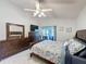 Well-lit bedroom featuring wood furniture, a ceiling fan, and sliding glass doors leading to the outdoors at 3720 Eversholt St, Clermont, FL 34711