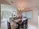 Open-concept dining room with modern chandelier and large window at 3720 Eversholt St, Clermont, FL 34711