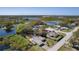 A beautiful aerial view of a home situated on a pond with mature trees and lush landscaping at 377 Ed Douglas Rd, Groveland, FL 34736